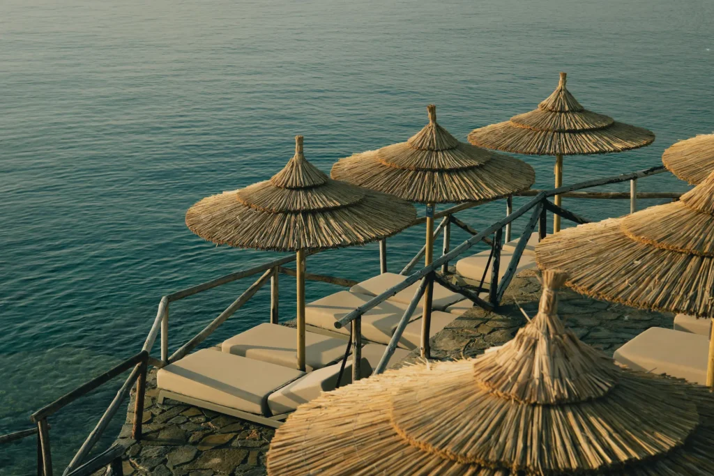 Sun beds overlooking the Mediterranean sea during golden hour, representing the lifestyle of expats moving to Spain in 2026 with help of an English insurance broker.