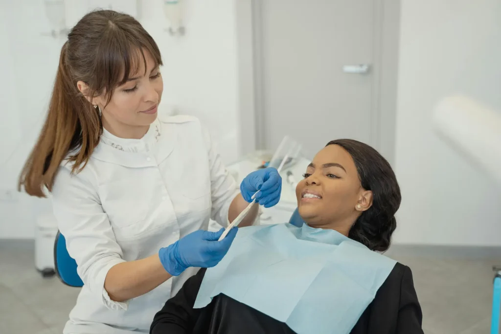 A lady receiving a dental check-up in a modern Mallorca dentist; illustrating comprehensive private health insurance plans that include premium dental care and specialist access for residents and expats.